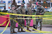 national guard standing behind police tape