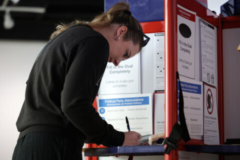 ARLINGTON, VIRGINIA - NOVEMBER 04: A voter cast her ballot at a polling station on November 4, 2025 in Arlington, Virginia. Virginians hit the poll on Election Day to pick their next governor. (Photo by Alex Wong/Getty Images)
