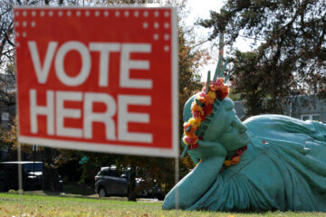 A lying Statue of Liberty is on display outside a polling station on November 4, 2025 in Arlington, Virginia. Virginians hit the poll on Election Day to pick their next governor. (Photo by Alex Wong/Getty Images)