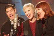 Jane Lynch (middle) sings with Tim Davis (left) and Kate Flannery (right)