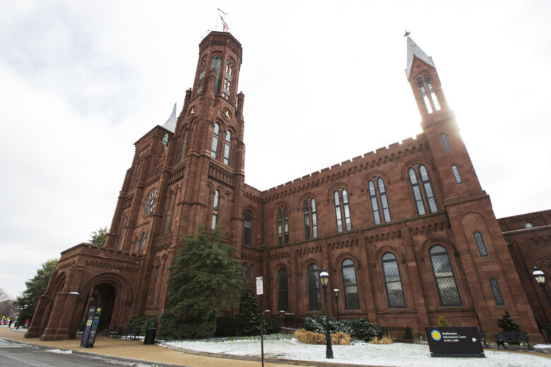FILE - The Smithsonian Institution's Smithsonian Castle is seen at the National Mall in Washington, Jan. 27, 2015. The Smithsonian will commemorate Women’s History Month in March 2022 by displaying 120 3D-printed statues depicting women who have excelled in the fields of science and technology. The life-size neon orange statues will be displayed in the Smithsonian Gardens and in select museums in the Smithsonian network in March. (AP Photo/Manuel Balce Ceneta, File)