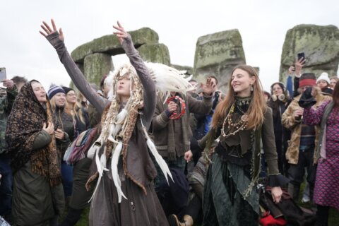 Thousands cheer as the sun rises on winter solstice at Stonehenge