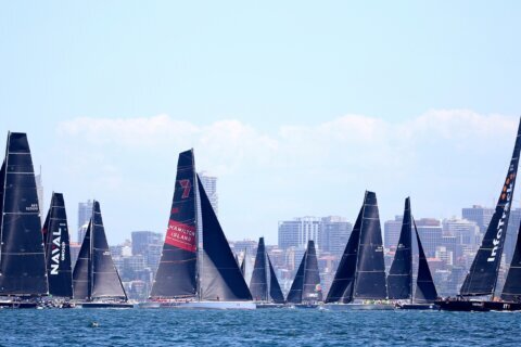 Defending champion LawConnect leads yachts out of Sydney harbor in annual ocean race to Hobart