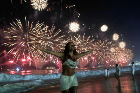 fireworks light up the sky over Copacabana Beach in Rio de Janeiro