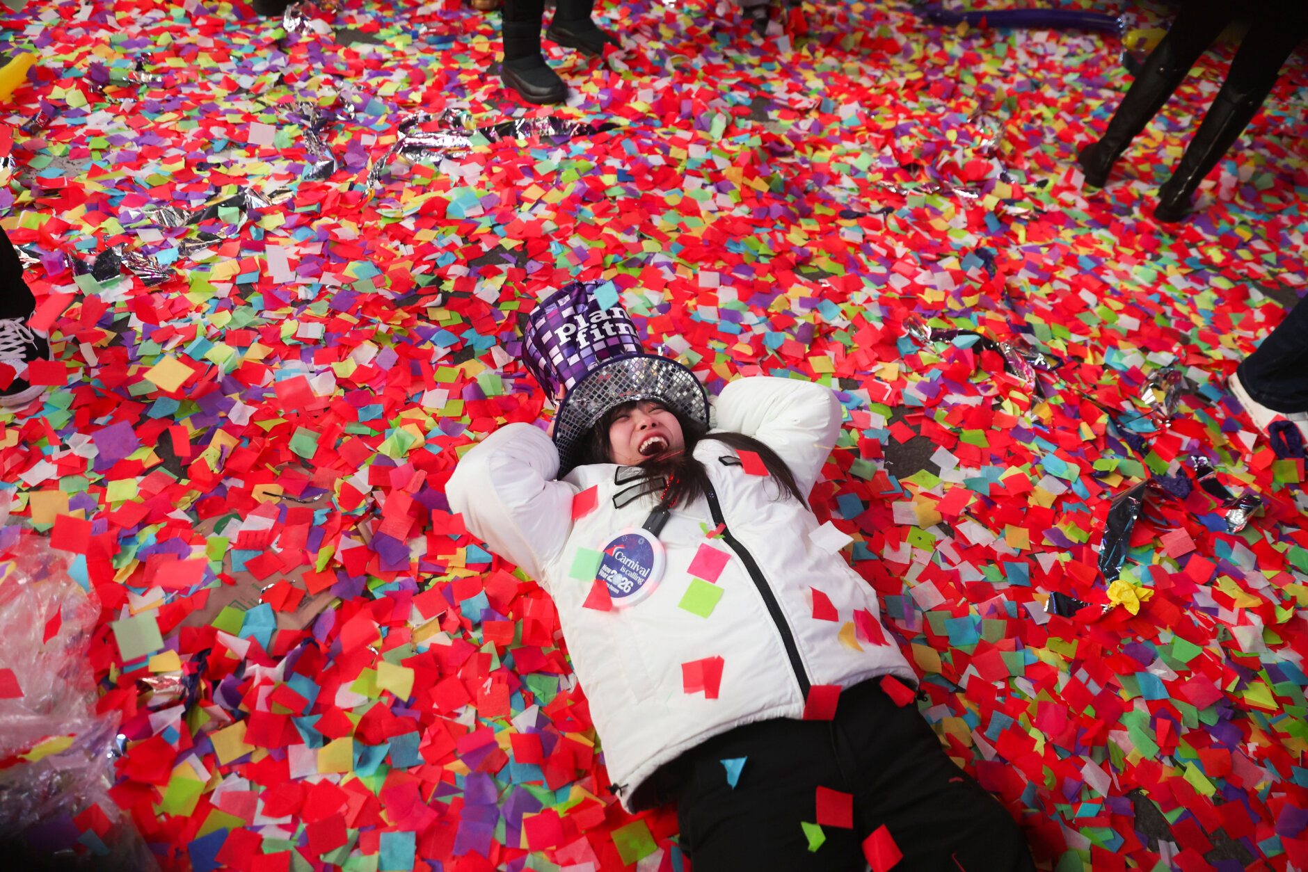 woman lays in confetti in New York