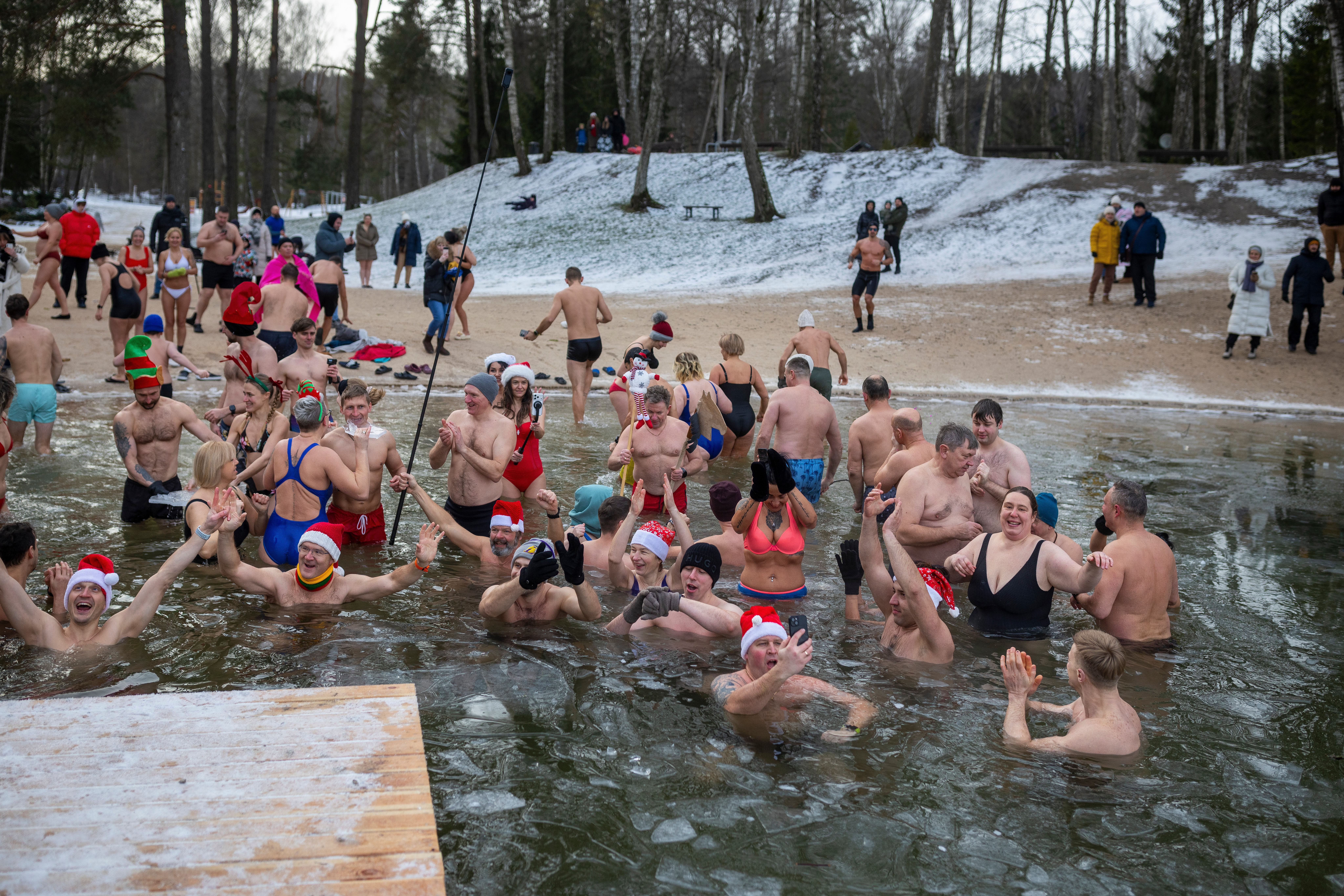 Swimmers get into the icy water in Lithuania