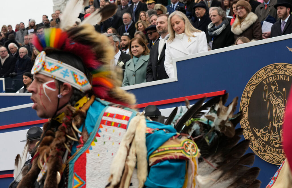 Gov. Abigail Spanberger, back center in white coat, attends an inaugural ceremony after she was sworn in as Virginia’s first female governor, at the Capitol in Richmond Va., Saturday, Jan. 17, 2026. (AP Photo/Steve Helber)