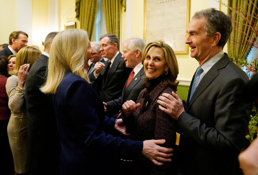 Virginia Gov.-elect, Abigail Spanberger, left, greets former Gov. Ralph Northam, right, and his wife, Pam Northam, center, during in inaugural ceremonies at the Capitol in Richmond Va., Saturday, Jan. 17, 2026. (AP Photo/Pool/Steve Helber)