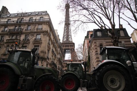 Farmers drive tractors through Paris and block highways in Greece to protest free trade deal