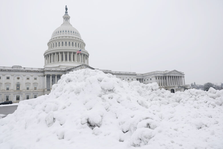 capitol dome with snow piled up in foreground