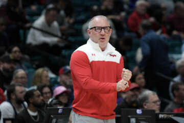 basketball coach stands courtside