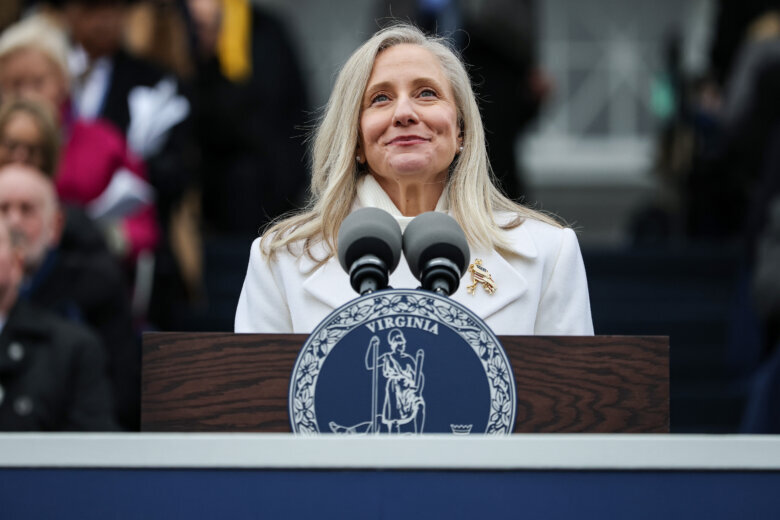 woman speaking at podium with microphones