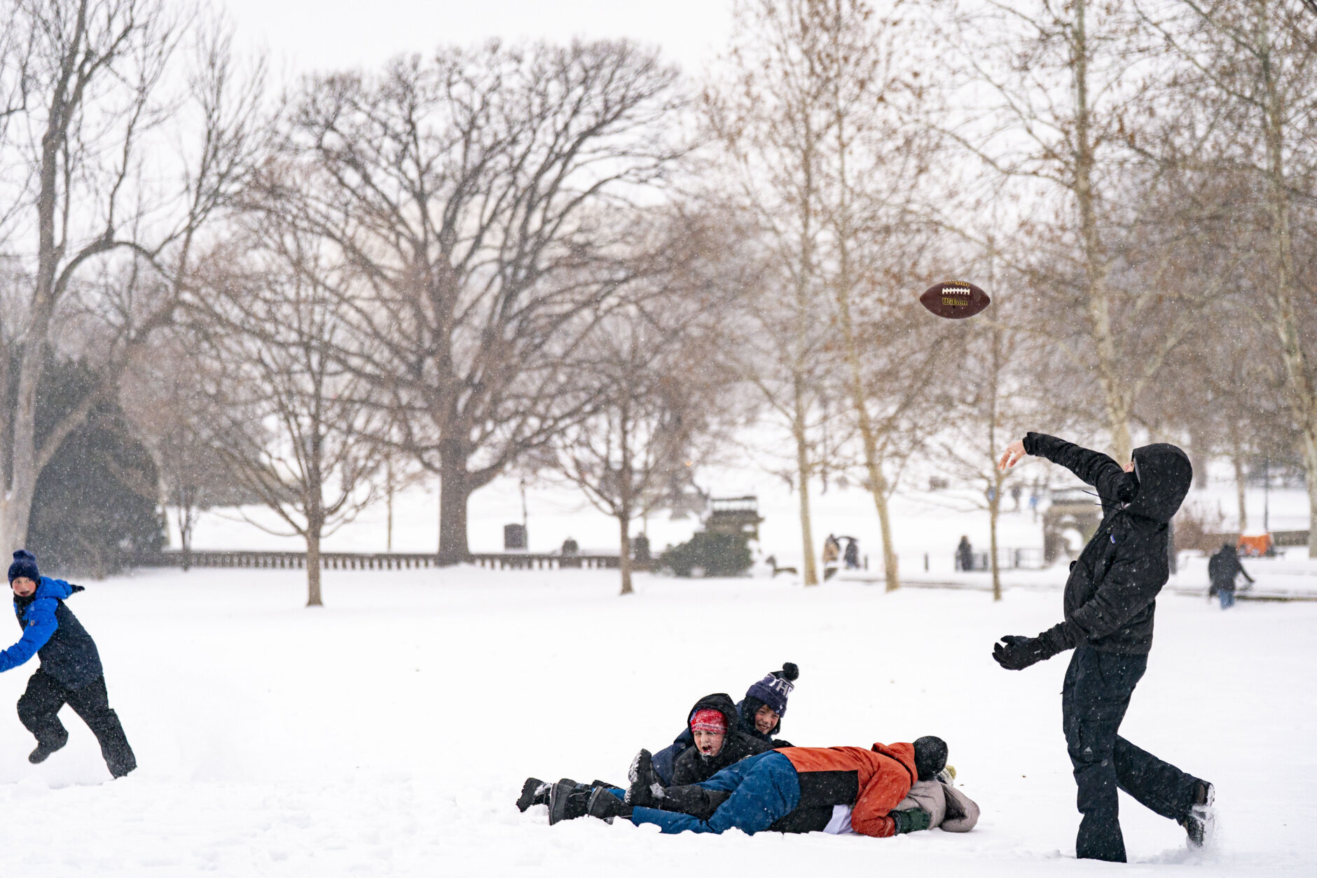 Children play football in the snow