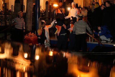 Olympic flame makes historic passage down Venice’s Grand Canal