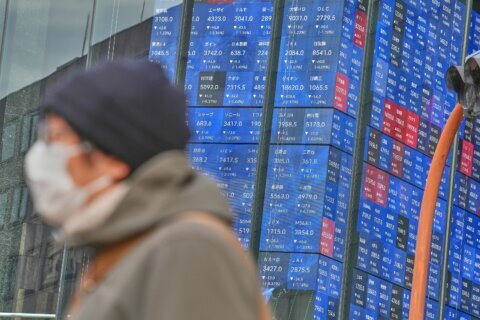 Asian shares are mixed after Wall St sets a record, and the US dollar’s value slides further