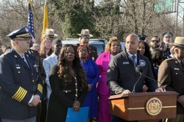 people speaking at a press conference