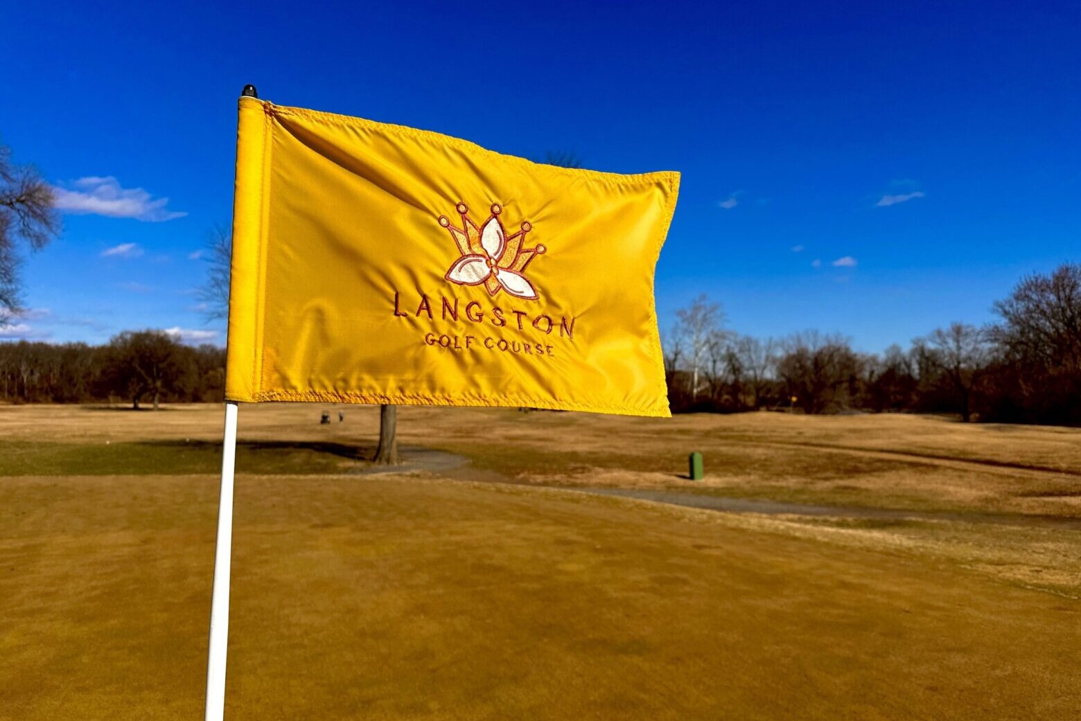 flag flies on flag pin at golf course