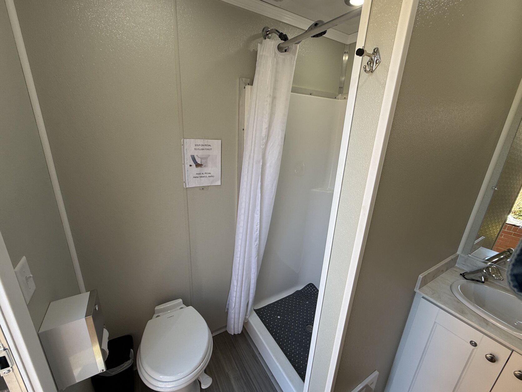 a toilet and shower in a mobile unit