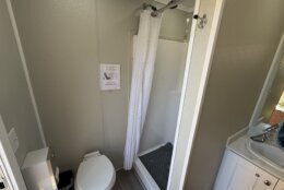 a toilet and shower in a mobile unit
