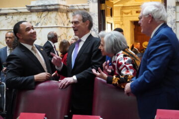From left, Sens. Antonio Hayes (D-Baltimore City), Brian Feldman (D-Montgomery) and Pamela Beidle (D-Anne Arundel) and former Sen. Jim Mathias share a laugh before the Senate gaveled in Wednesday on the first day of 2026 legislative session.