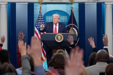 Trump recaps his first year back in office with winding remarks, paper tossing and impressions