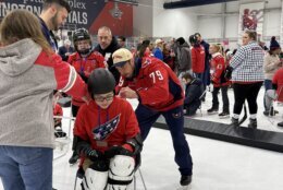 Lindgren signs an autograph for a kid on the ice.