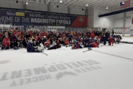 kids with disabilities pose for a group photo with caps players