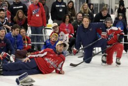 kids pose on the ice with capitals players