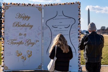 People look at a protest art installation on the National Mall on January 19 in Washington, DC.