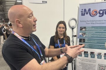 man at tech exhibit explaining display