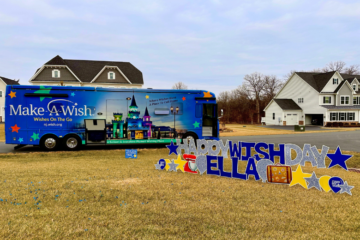 a big blue bus on a lawn