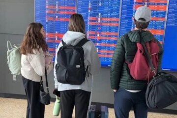 Passengers check on their flights at Dulles Airport.