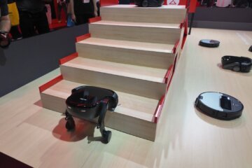 a robotic vacuum cleans a set of stairs at tech showcase