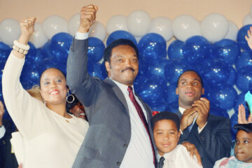 Jesse Jackson is joined by his daughter, Santita, and son Jonathan, far right, and unidentified youngster at the Los Angeles Hilton Hotel, June 8, 1988 after falling in defeat to Massachusetts Gov. Michael Dukakis in the California Democratic primary. (AP Photo/John Duricka, File)