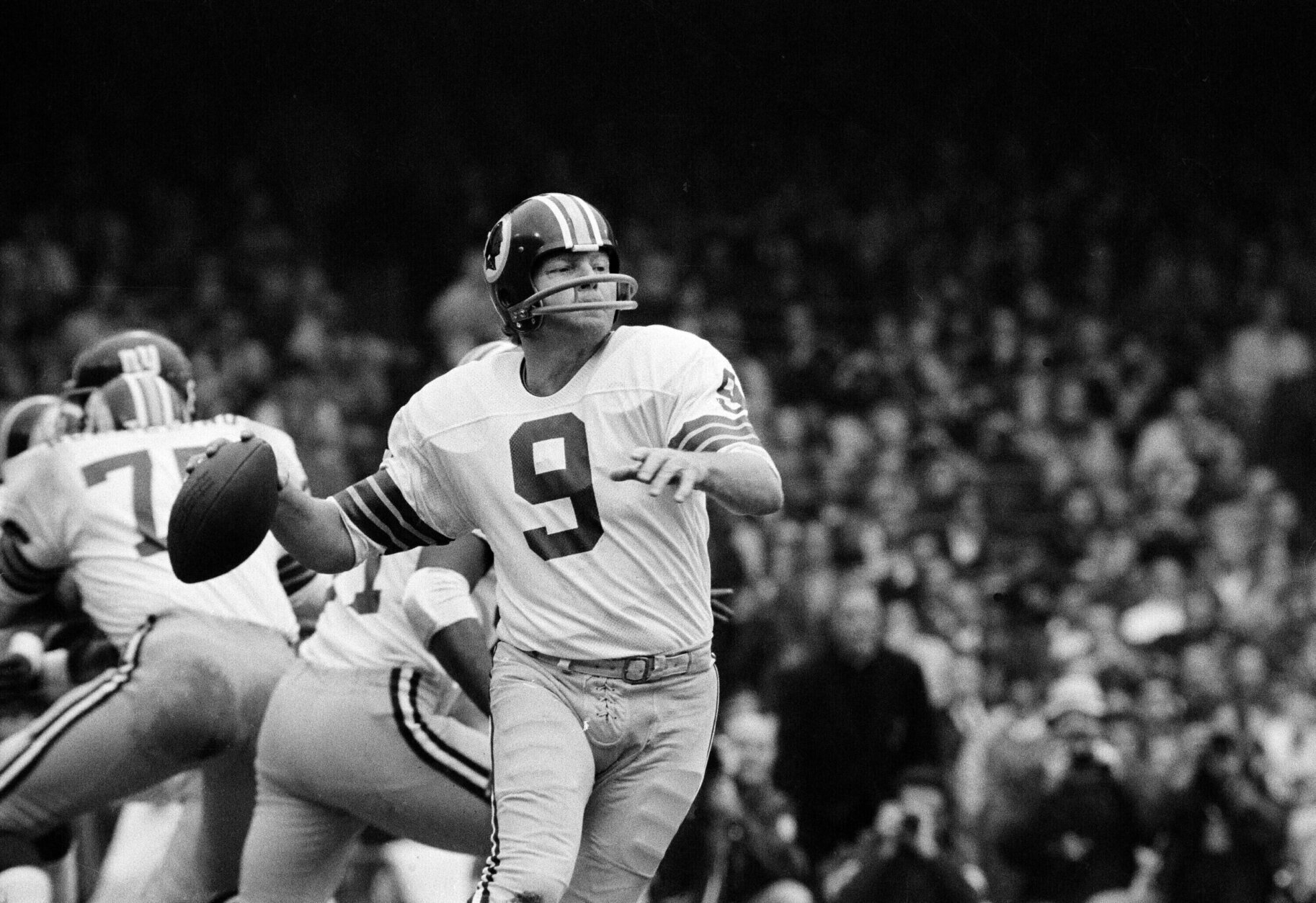 FILE - Washington quarterback Sonny Jurgensen looks to pass against the New York Giants during an NFL football game in 1974. (AP Photo/File)