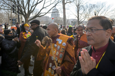 With the Capitol in the background, Bhikkhu Pannakara, center, leads his fellow Buddhist monks near the Peace Monument on Capitol Hill, during the Walk for Peace, in Washington, Wednesday, Feb., 11, 2026. (AP Photo/Rod Lamkey, Jr.)