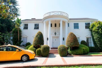A yellow cab drives by the "Fresh Prince of Bel Air" mansion, just like in the series opening credits, on September 24, 2020, in Brentwood, California. - The "Fresh Prince of Bel-Air" series, which launched Will Smith's career on television, is celebrating its 30th anniversary. The house where the Banks family lives in the show is available for rent via Airbnb, for $30 a night, for 30 days. The house, which is 6400 sq.ft and worth more than $6 millions, was used for exterior establishing shots in the series, but interior live-actions was shot in a Los Angeles studio. (Photo by VALERIE MACON / AFP) (Photo by VALERIE MACON/AFP via Getty Images)