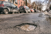 A large pothole in the road.