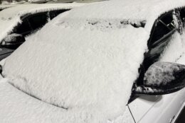 Snow on the windshield of car after snowstorm.