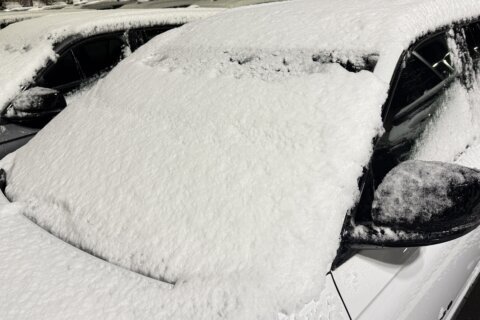 Snow on the windshield of car after snowstorm.