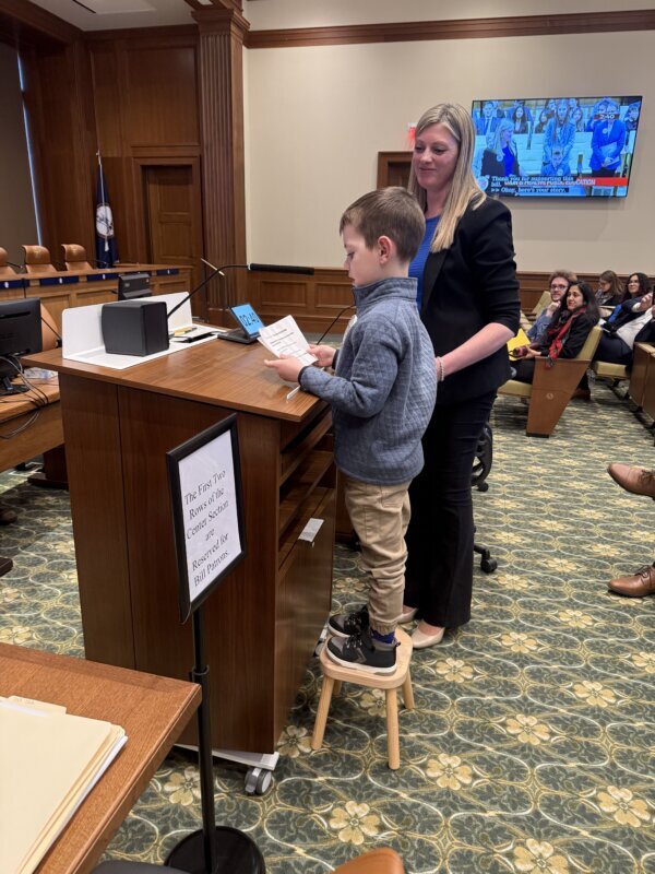 ruston stands at podium talking