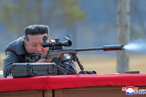 North Korea’s Kim gifts rifles to officials and his daughter takes aim after party congress