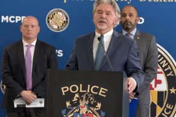 three men speak at a press conference
