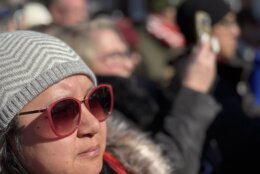 A woman joins a crowd in Alexandria in listening to the monks' message on Feb. 9, 2026.
