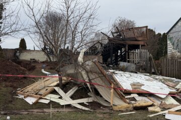 rubble is seen after a home explosion in a suburban neighborhood
