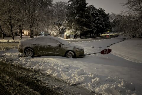 Car runs into stop sign after Sunday snow.
