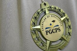 A medal that reads "Exemplar of Excellence PGCPS"