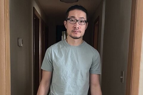 Chinese national who exposed rights abuses is freed from US detention after being granted asylum