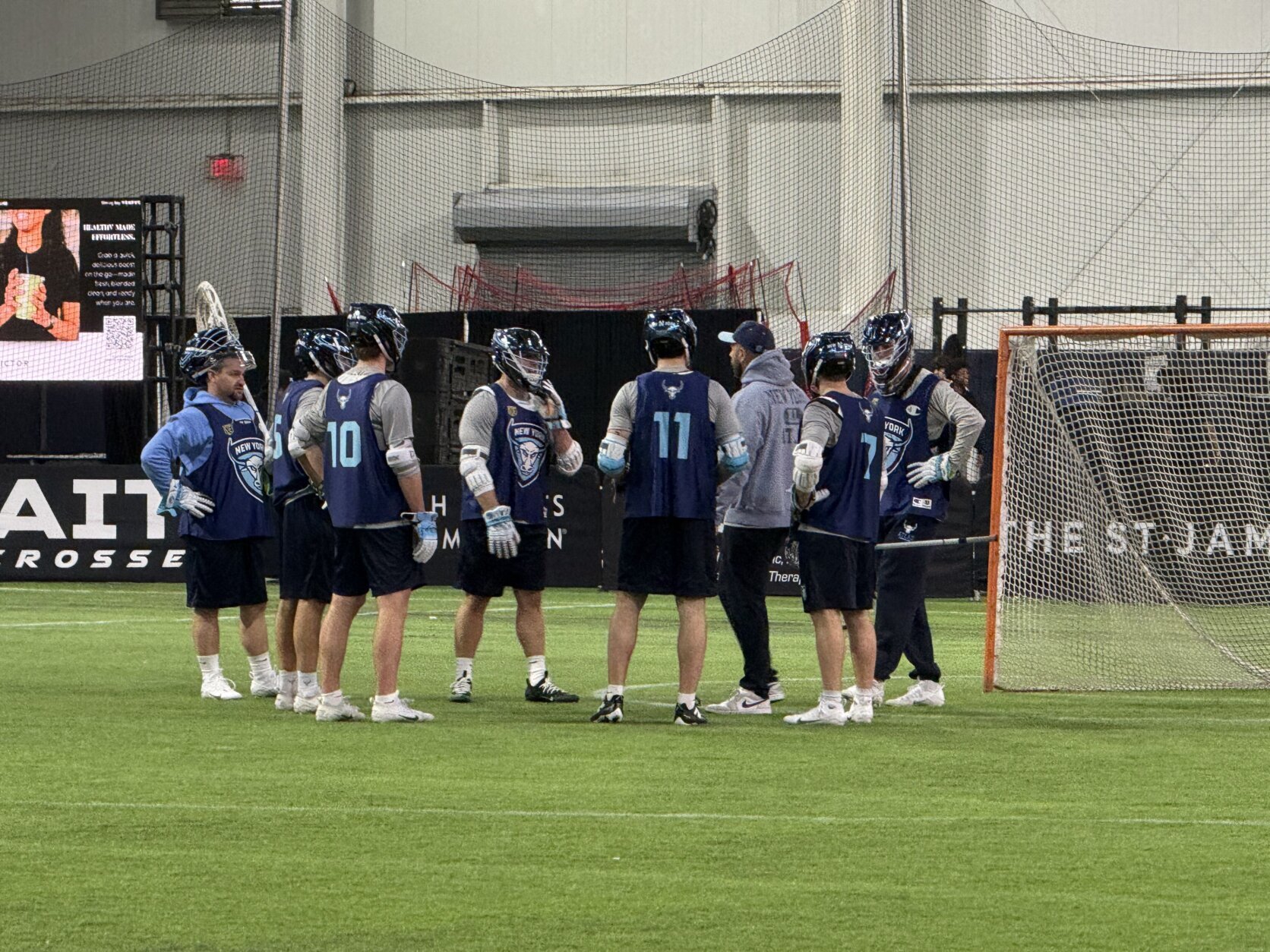 lacrosse players talking in huddle