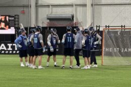 lacrosse players talking in huddle